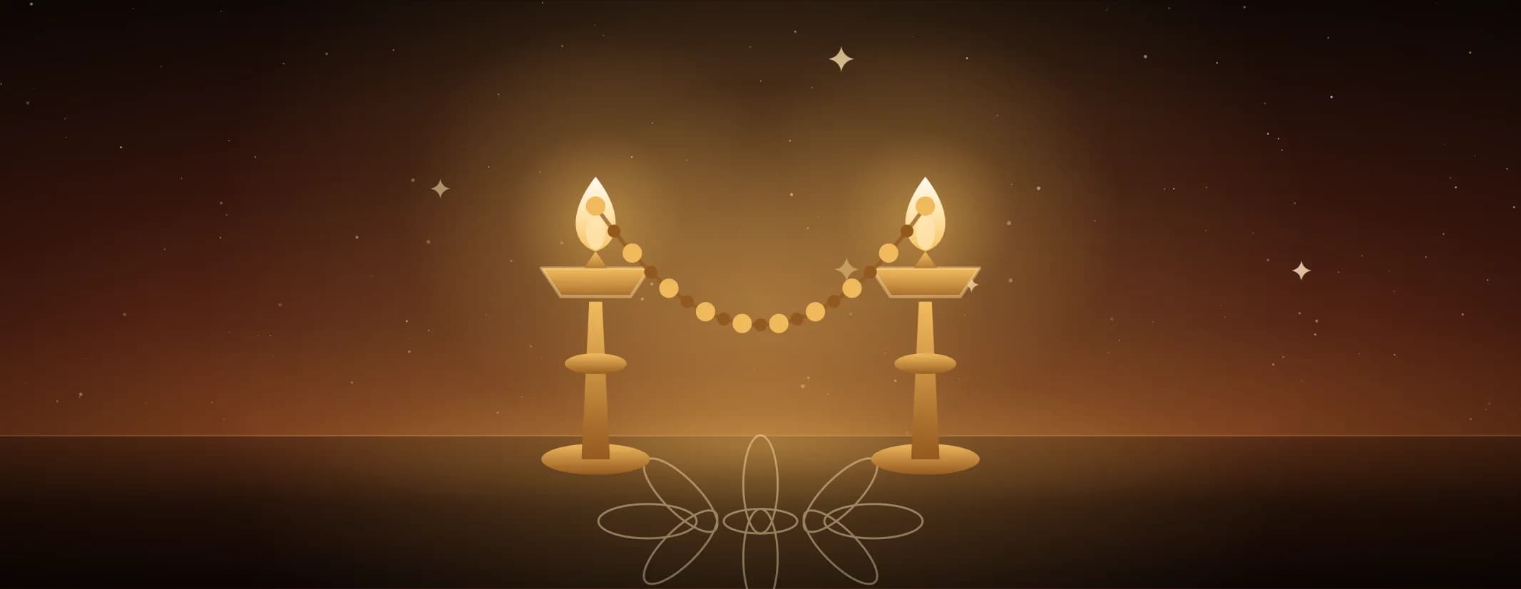 A pair of lit brass lamps with a strung garland dipping between them, standing on a kolam against a sunrise sky.